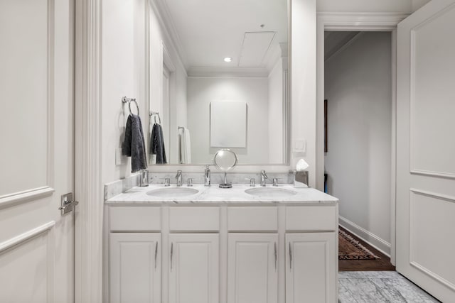 bathroom featuring crown molding, recessed lighting, a sink, and double vanity