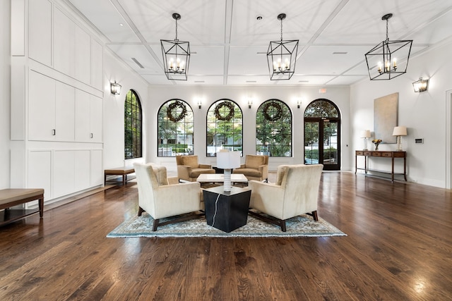 interior space with plenty of natural light, coffered ceiling, and wood finished floors