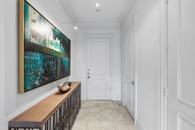 corridor with marble finish floor and crown molding