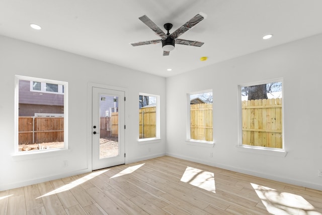 unfurnished sunroom with a ceiling fan