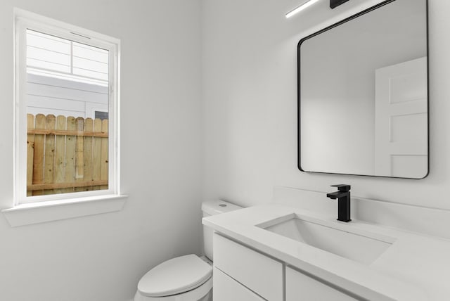 bathroom with toilet and vanity