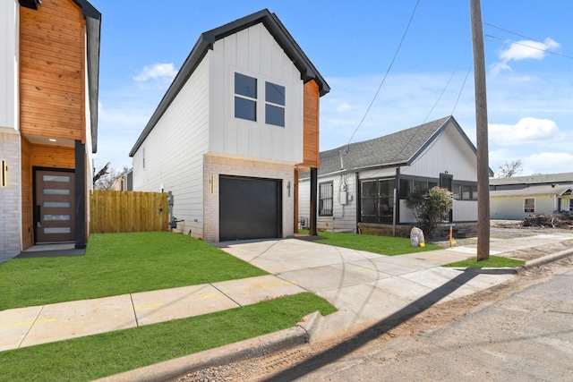 view of front of house with brick siding, board and batten siding, a garage, driveway, and a front lawn