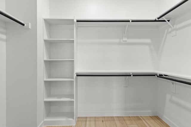 walk in closet with light wood-type flooring