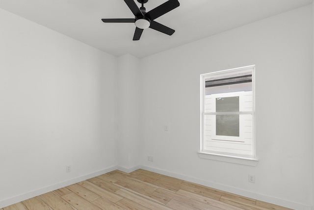 empty room with light wood-type flooring, ceiling fan, and baseboards