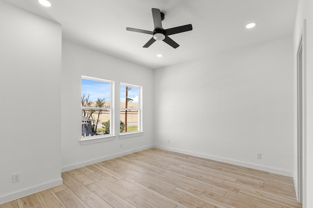 empty room featuring light wood-style flooring, baseboards, a ceiling fan, and recessed lighting