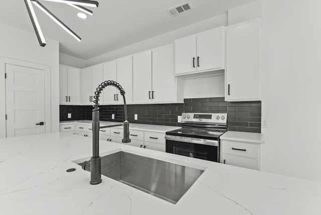 kitchen featuring tasteful backsplash, a sink, visible vents, and stainless steel electric stove