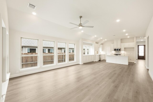 119 Emperor Oak Ct, Balch Springs, TX 75181 - unfurnished living room featuring healthy amount of natural light, a ceiling fan, light wood-style flooring, vaulted ceiling, and recessed lighting