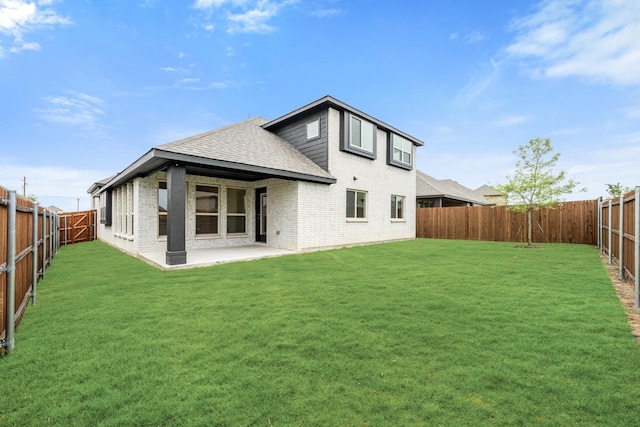 119 Emperor Oak Ct, Balch Springs, TX 75181 - back of house with roof with shingles, brick siding, and a patio area