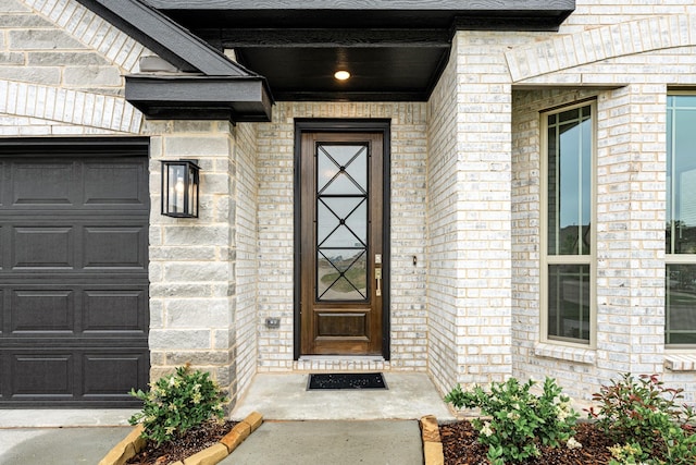119 Emperor Oak Ct, Balch Springs, TX 75181 - doorway to property featuring an attached garage and brick siding