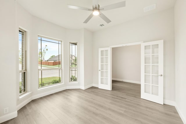 119 Emperor Oak Ct, Balch Springs, TX 75181 - empty room with french doors, light wood-type flooring, baseboards, and ceiling fan
