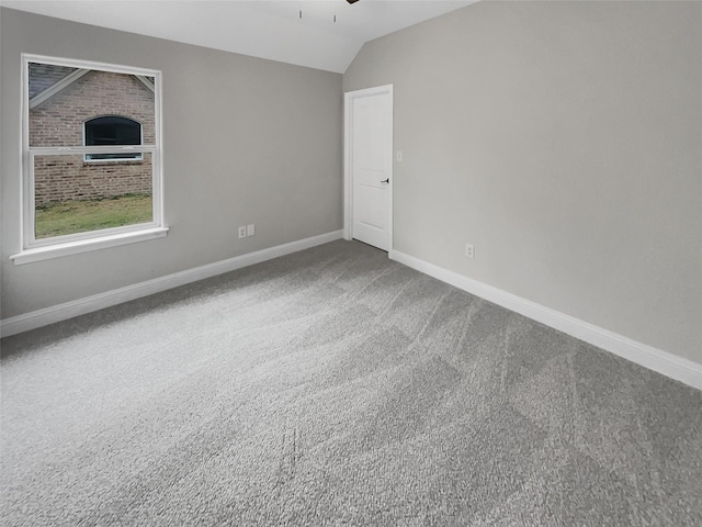 unfurnished bedroom with ceiling fan, baseboards, vaulted ceiling, and carpet flooring