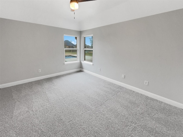 spare room featuring carpet flooring, ceiling fan, and baseboards