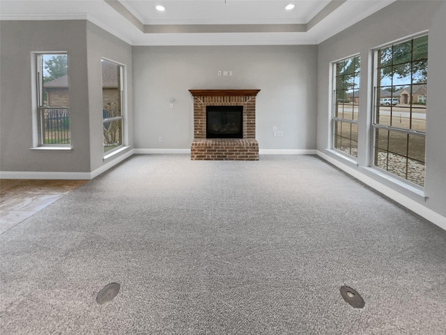 unfurnished living room with ornamental molding, carpet flooring, and baseboards