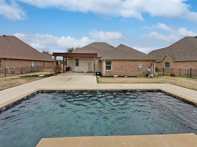 view of swimming pool featuring a patio area, a fenced backyard, a lawn, and a fenced in pool