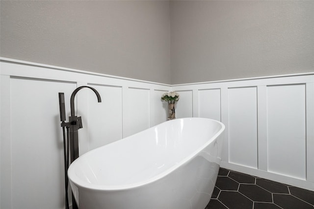 12510 Liberty School Rd, Azle, TX 76020 - full bath featuring a freestanding tub, a wainscoted wall, a decorative wall, and tile patterned flooring