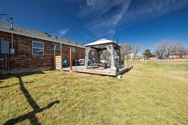 view of yard with a wooden deck and a gazebo