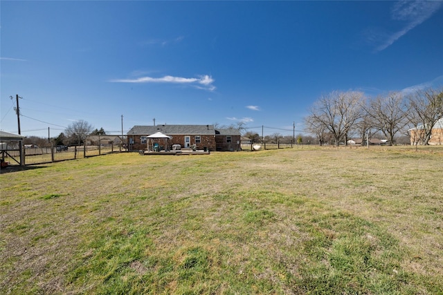 view of yard with a rural view and fence