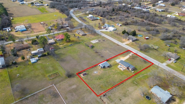 birds eye view of property with a rural view