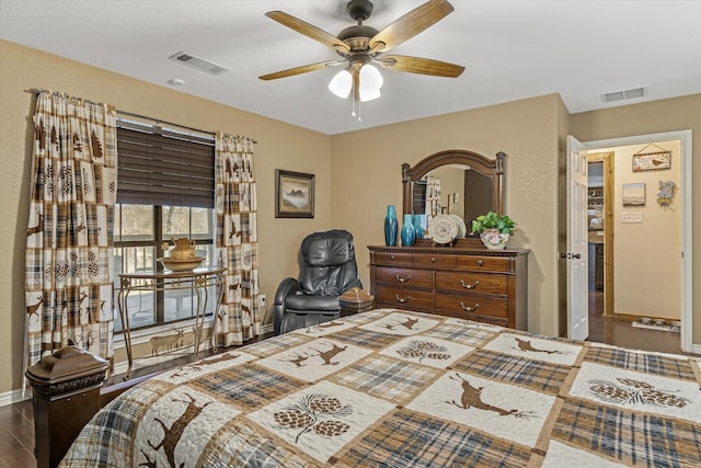 bedroom with a ceiling fan, baseboards, visible vents, and wood finished floors