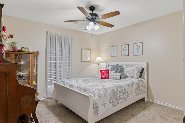 carpeted bedroom with access to exterior, a ceiling fan, and baseboards