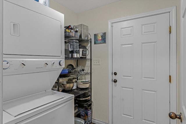 laundry area with stacked washer and clothes dryer and laundry area