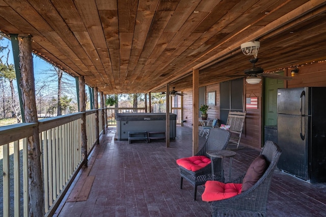 view of patio / terrace with a ceiling fan and a hot tub