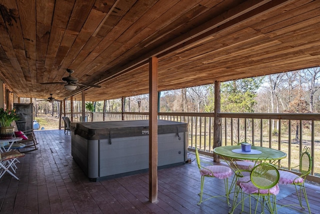 wooden terrace featuring a hot tub and a ceiling fan