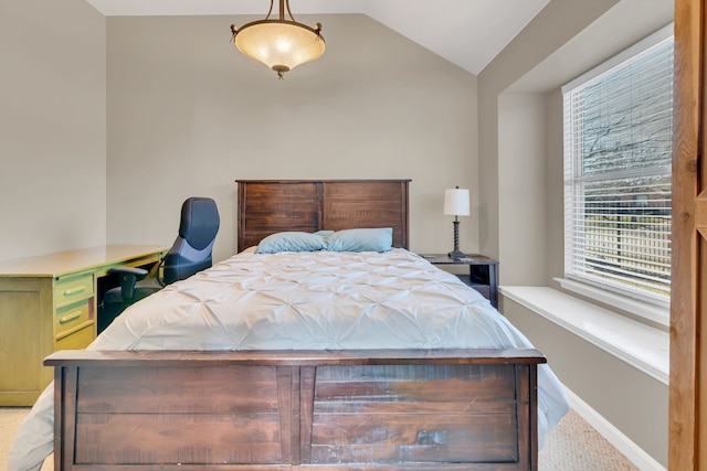 bedroom with vaulted ceiling and baseboards