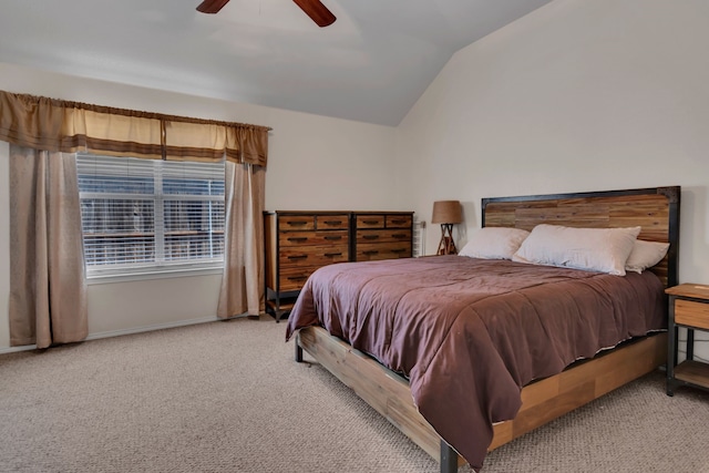 carpeted bedroom with ceiling fan, baseboards, and vaulted ceiling