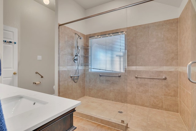 bathroom with a shower stall and vanity