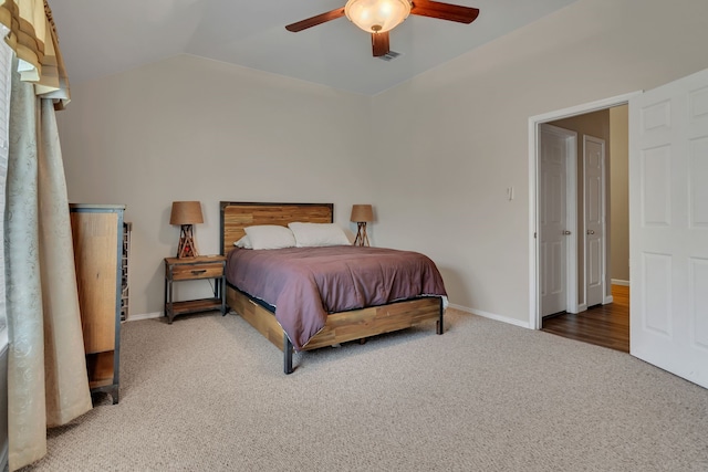 bedroom featuring ceiling fan, carpet, baseboards, and vaulted ceiling