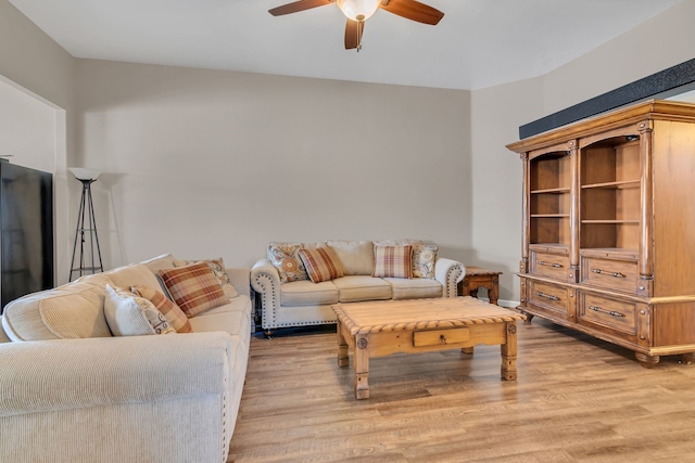 living room featuring light wood finished floors and ceiling fan