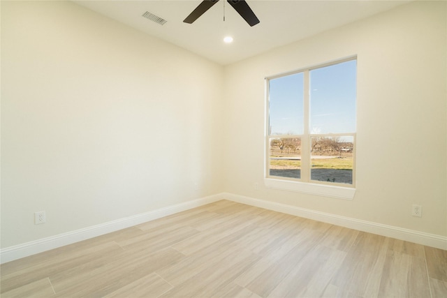 unfurnished room with light wood-type flooring, visible vents, baseboards, and recessed lighting