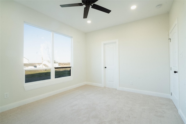 empty room with recessed lighting, light carpet, ceiling fan, and baseboards