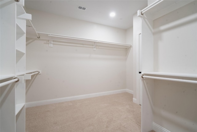 spacious closet featuring visible vents and carpet flooring