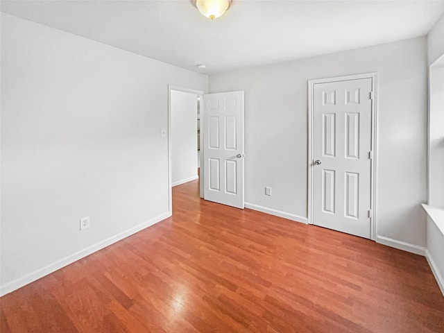 unfurnished bedroom featuring baseboards and light wood-style floors