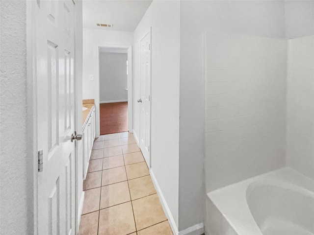 full bath with visible vents, vanity, tile patterned flooring, and a bathing tub