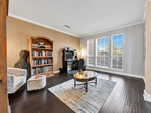 living area featuring baseboards, wood finished floors, visible vents, and crown molding