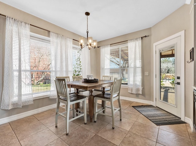 dining space featuring light tile patterned floors, baseboards, and a notable chandelier