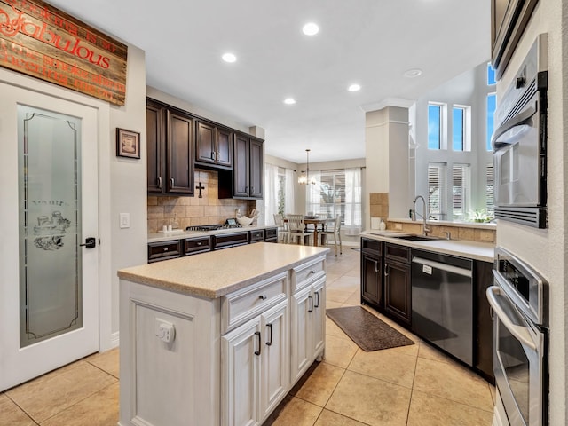 kitchen with light tile patterned floors, recessed lighting, backsplash, appliances with stainless steel finishes, and dark brown cabinetry