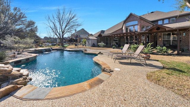 pool featuring an outbuilding, a patio, and a shed