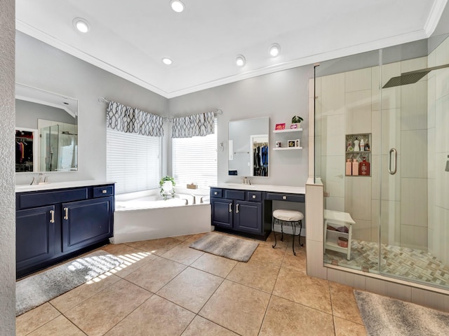 bathroom with a garden tub, a shower stall, ornamental molding, and a sink