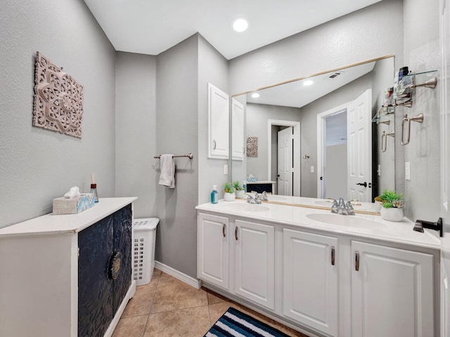 full bath featuring double vanity, recessed lighting, a sink, and tile patterned floors