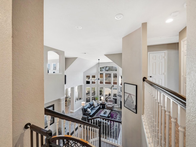 hallway with recessed lighting, baseboards, and an upstairs landing