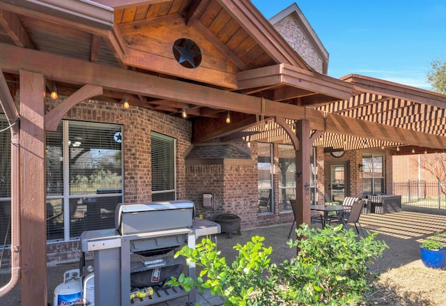 view of patio / terrace with fence, grilling area, and a pergola