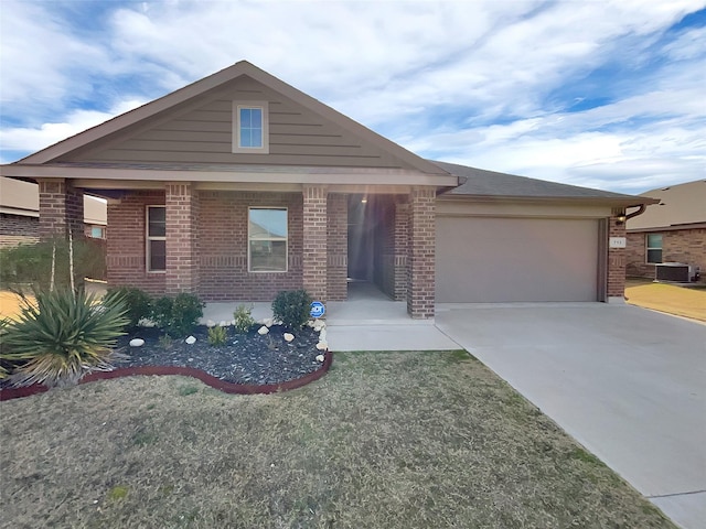 view of front of property with an attached garage, central air condition unit, concrete driveway, and brick siding