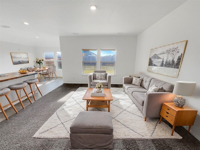 carpeted living area with recessed lighting and baseboards