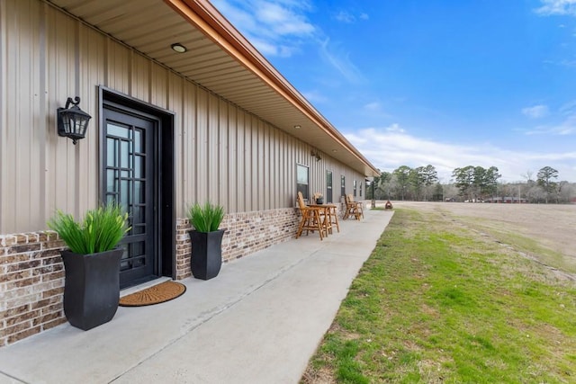 view of side of property featuring brick siding and a yard