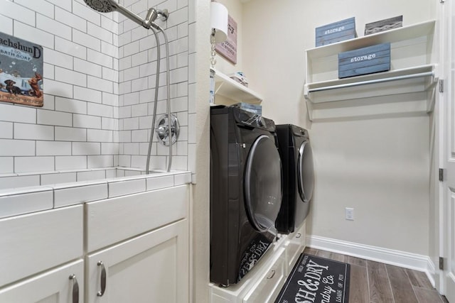 bathroom with separate washer and dryer, walk in shower, wood finished floors, and baseboards