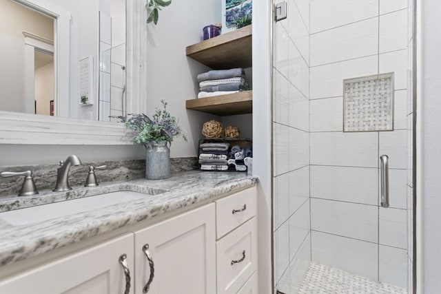 bathroom featuring a shower stall and vanity